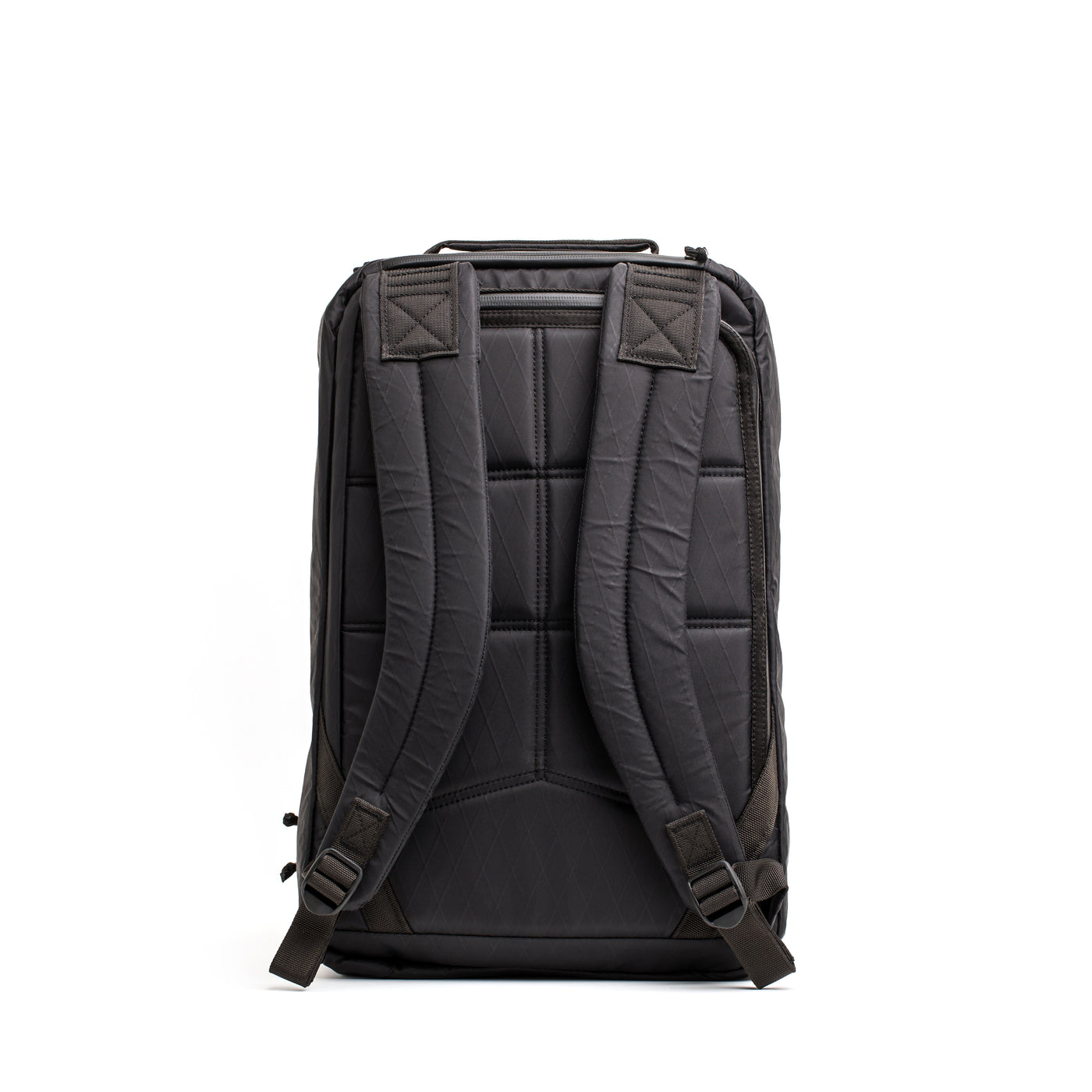 The GORUCK GR1 USA - X-PAC, a black rucksack featuring padded straps and a minimalist design, crafted from waterproof material, is shown from the back against a white background.