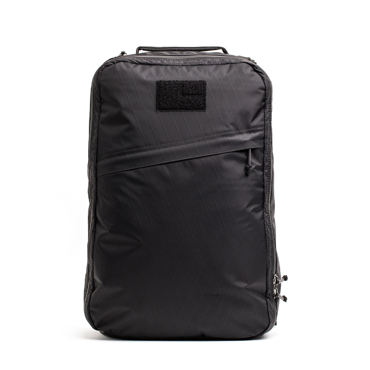 The GR1 USA - X-PAC is a sleek black backpack with AquaGuard zippers and a small patch on the top front.