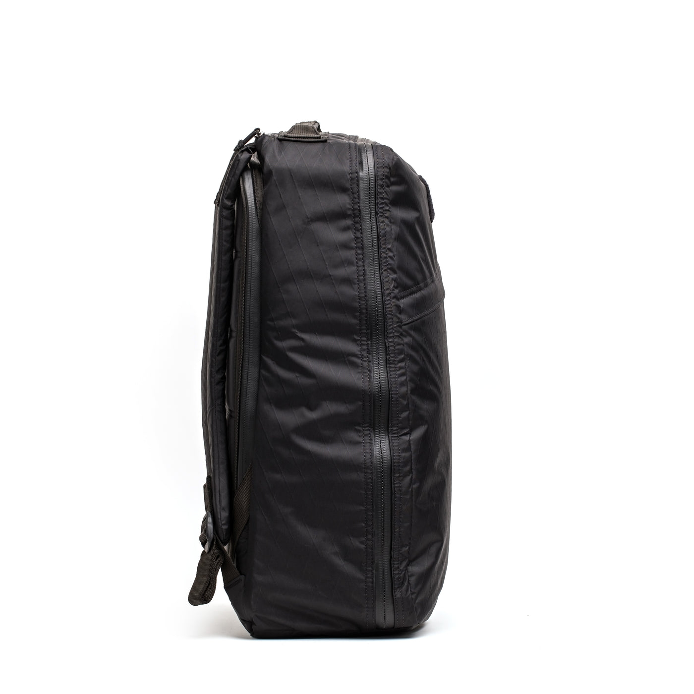 Side view of the GR1 USA - X-PAC by GORUCK, featuring its sleek black design and AquaGuard zippers, set against a white background for added emphasis.