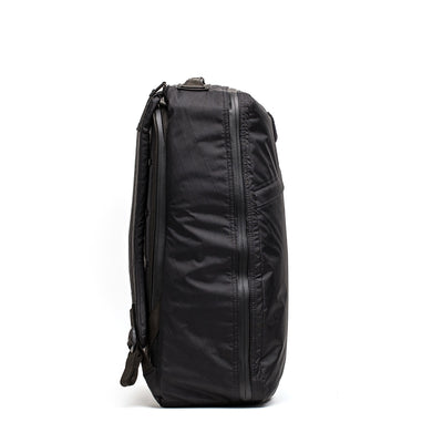 The GR1 USA - X-PAC backpack is displayed in a side view against a stark white background, featuring waterproof X-PAC material and AquaGuard zippers for enhanced protection.