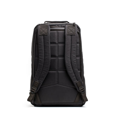 The GR1 USA - X-PAC by GORUCK is a black backpack featuring padded shoulder straps, a quilted back panel, and AquaGuard zippers, displayed upright on a white background.