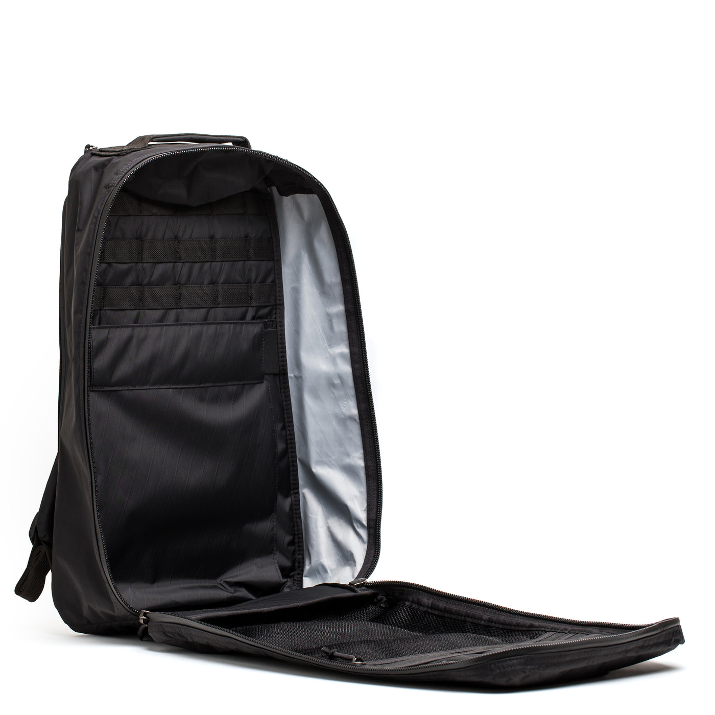 The GR1 USA - X-PAC backpack by GORUCK, made with X-PAC fabric, features multiple compartments and AquaGuard zippers. It is fully unzipped and open, displayed from the side.