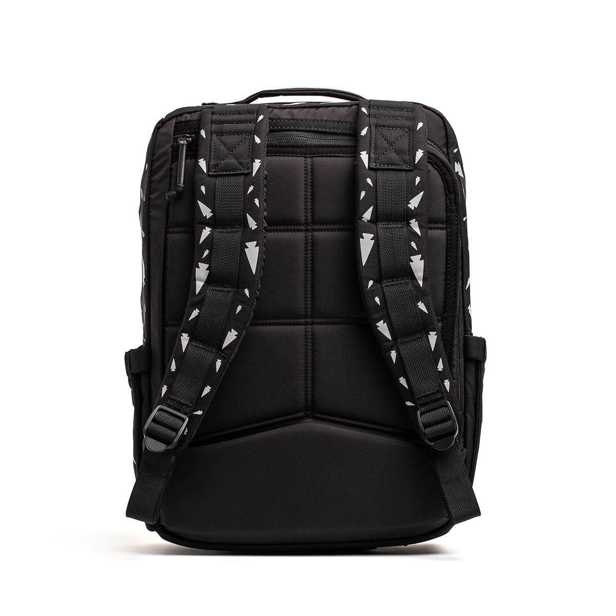 Introducing the KR1 - Spearhead Splatter from GORUCK, a sleek and modern black kids' rucksack. It features padded shoulder straps and displays a geometric white arrow pattern. This book bag comes with a quilted back panel for added comfort and has several visible side straps for easy adjustments, making it perfect for carrying school supplies.