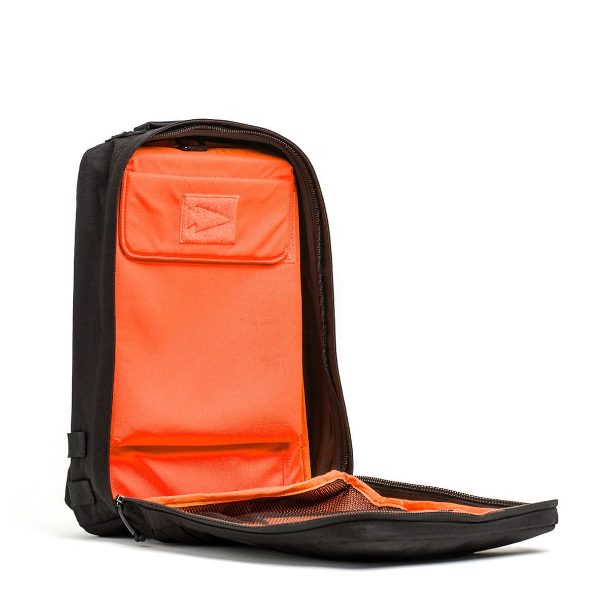 The Rucker 4.0 black backpack, with a bright orange interior, is slightly open to showcase its organized compartments, ideal for all your rucking adventures.