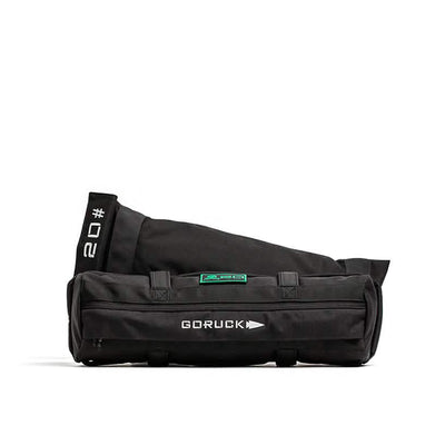 The black GORUCK Sandbag Kit, featuring reinforced handles and a printed 20-pound label, ensures durability and a lifetime guarantee against a white background.