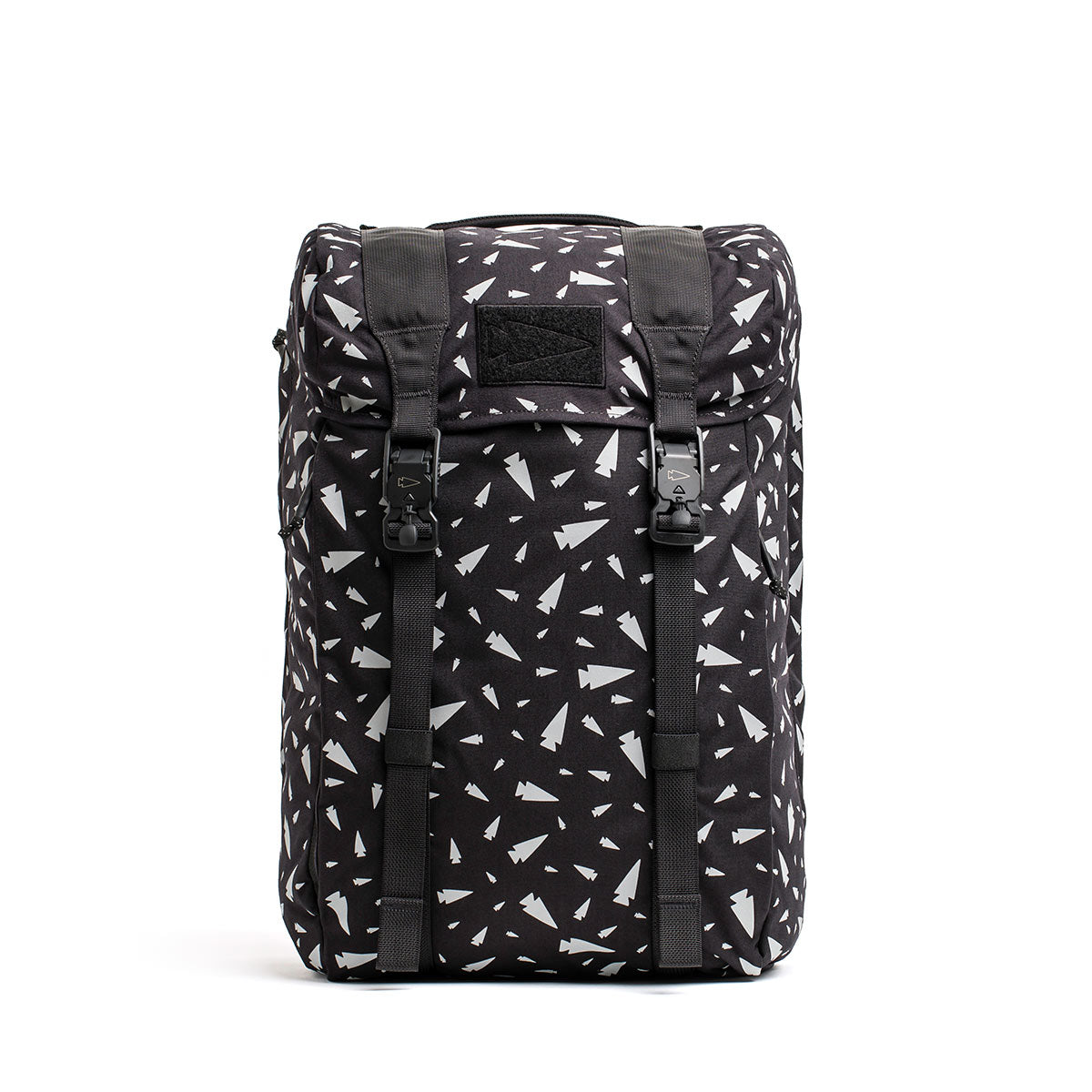 Introducing the GORUCK M23 - Cordura - Spearhead Shrapnel: a black rucksack with a white geometric design. This stylish backpack features two front buckles and a top flap closure, crafted from durable materials. The abstract pattern of scattered triangles and shapes gives it a modern flair.