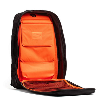 Open black GORUCK Rucker 4.0 backpack displaying a vibrant orange interior with various compartments, ideal for rucking adventures.