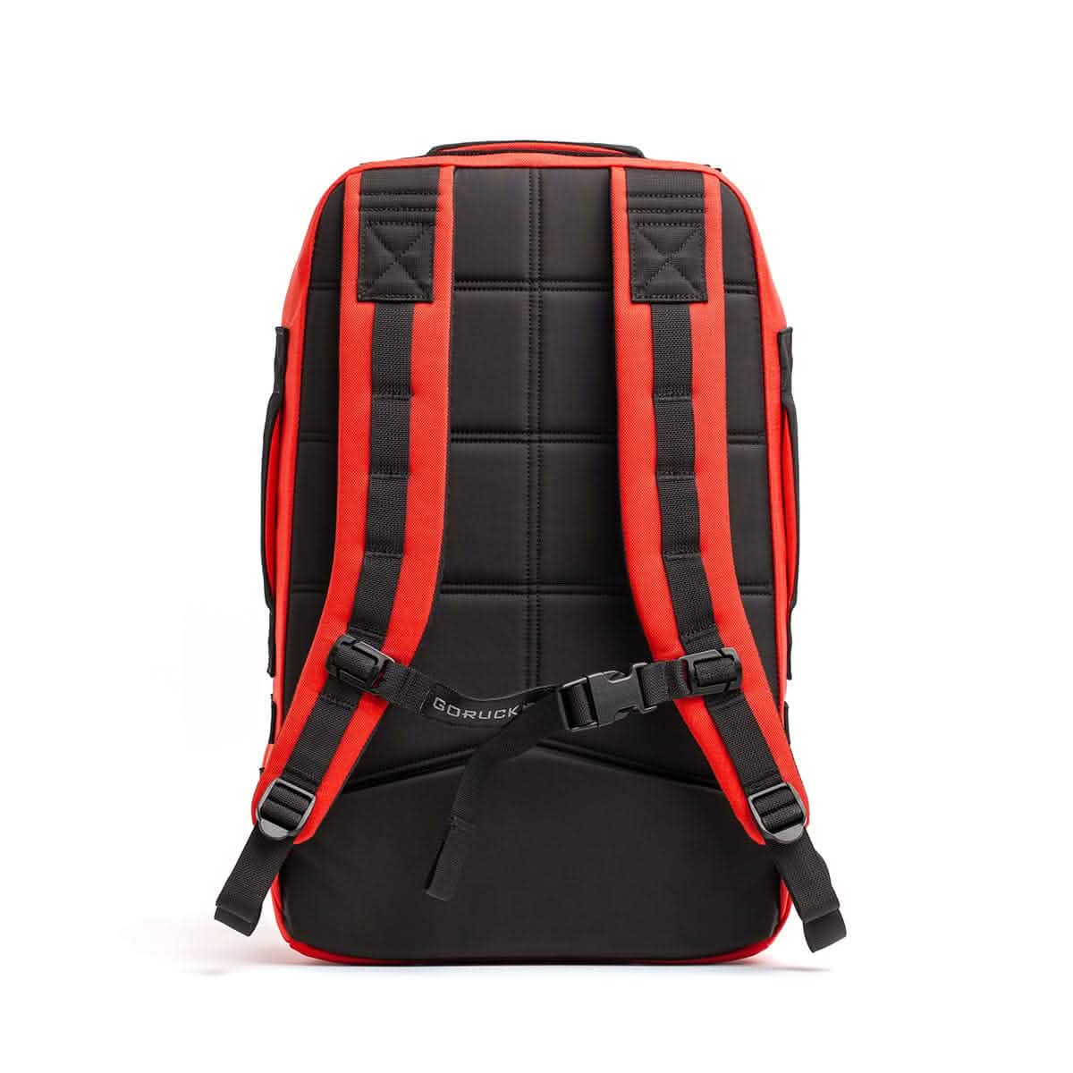 The Rucker 4.0 by GORUCK, seen from the back, features padded straps and an adjustable chest buckle, making it perfect for rucking adventures with its black and red design.