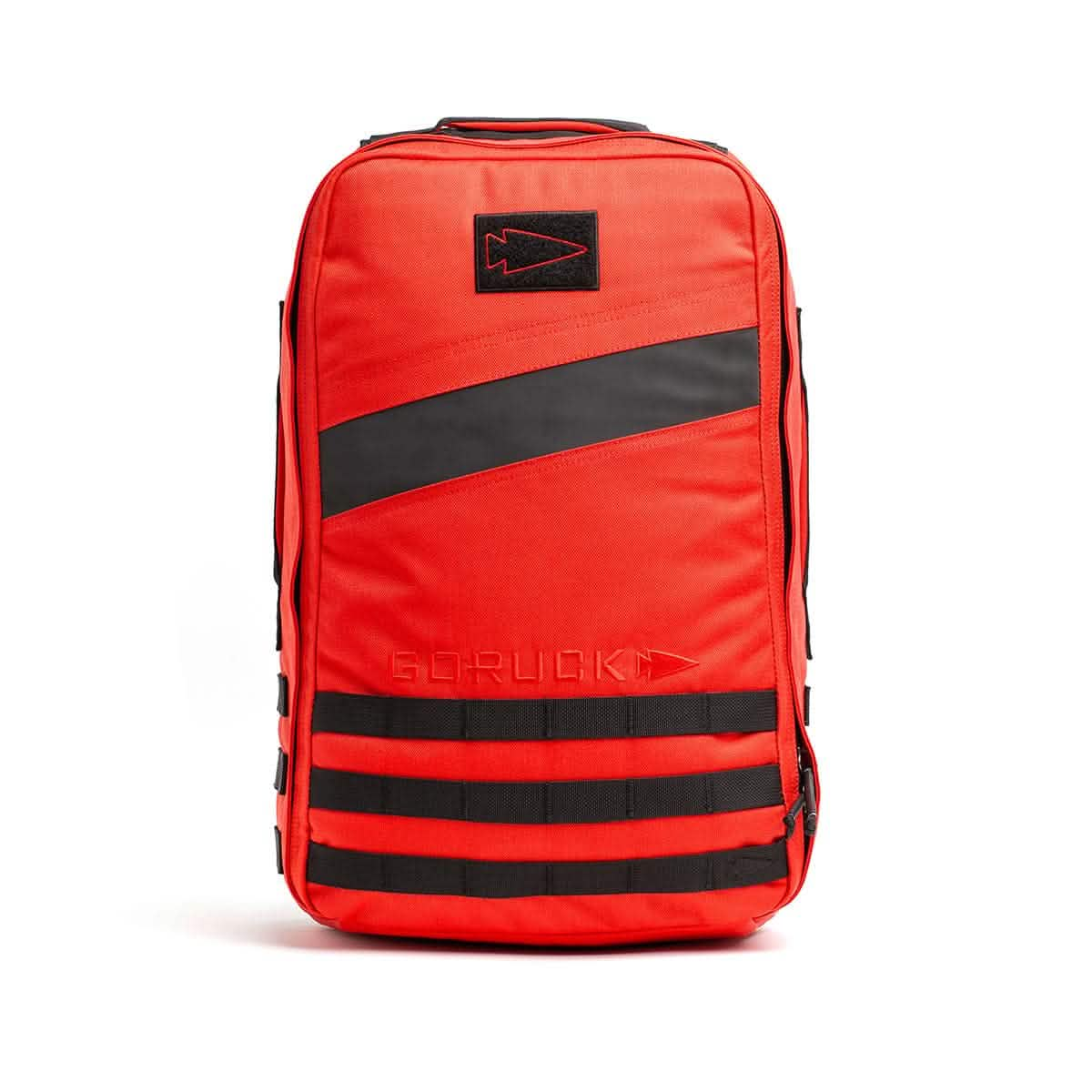 The vibrant Rucker 4.0 backpack from GORUCK, featuring a bold orange color with black stripes and logo, offers multiple compartments and reinforced stitching, making it ideal for rucking adventures.