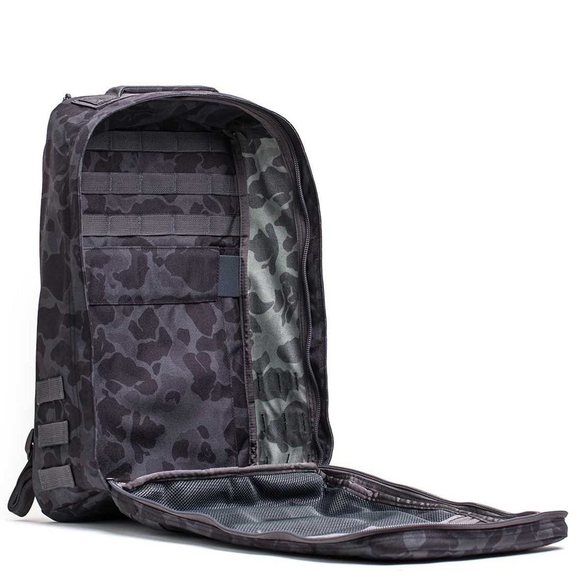 Show the interior compartments of the open GR1 USA - Cordura (The Original Ruck) in black camouflage, reminiscent of a Special Forces rucksack, on a white background.