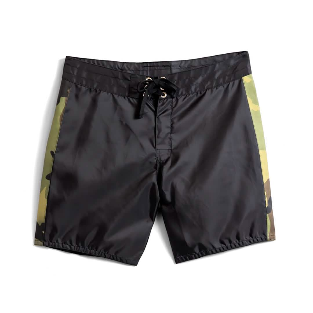 The 300 Boardshorts – GORUCK are black men's boardshorts featuring camouflage side panels and a SurfNyl lace-up drawstring closure at the waist. Made in the USA, these shorts are shown against a white background.