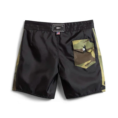 Men's boardshorts featuring a black and camouflage design with a single button-flap pocket. These 300 Boardshorts combine solid black with camouflage side patterns and include a waistband tag displaying the brand name Birnell x GORUCK, proudly made in the USA.