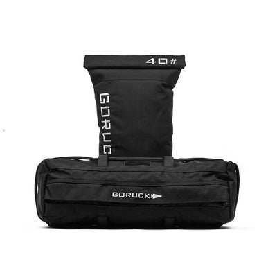 A black Sandbag Kit with a 40 lb filler bag, both showcasing the GORUCK logo on a plain white background. Built for durability and versatility, these sandbags have reinforced handles and include a lifetime guarantee.