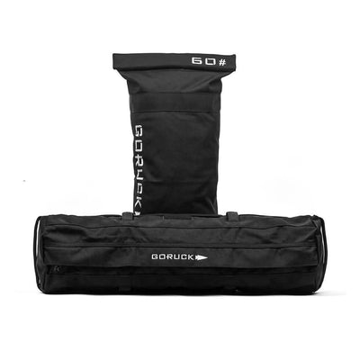 Black GORUCK Sandbag Kit with reinforced handles and filler tube, marked "60," on a white backdrop. Perfect for training sessions and includes a lifetime guarantee.