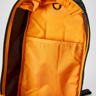 The Bullet Ruck - Ripstop ROBIC® by Michael Easter features a vivid orange interior, crafted from durable 420D ROBIC® Ripstop Nylon. It includes an inner pocket, combining style and functionality in a lightweight backpack design.