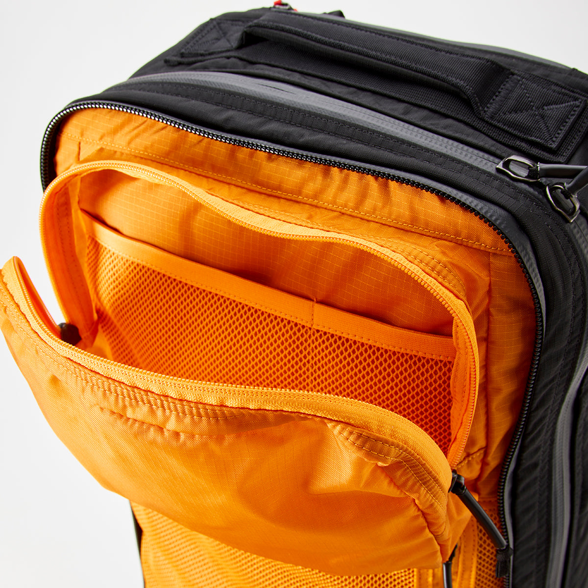 The GR2 - Ripstop ROBIC® - Michael Easter backpack displays a bright orange interior and a mesh pocket, crafted from robust 420D ROBIC Ripstop Nylon.