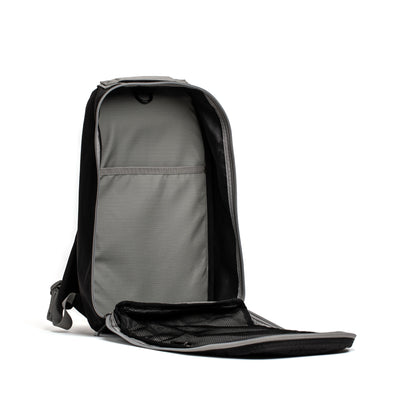 The GORUCK Bullet Ruck Laptop - Ripstop ROBIC® - 16L is a durable open black and gray backpack with a spacious main compartment and an open front flap. Inside, it features a smaller pocket for organization. Designed to stand upright with the interior facing forward, it caters to those seeking both style and resilience.