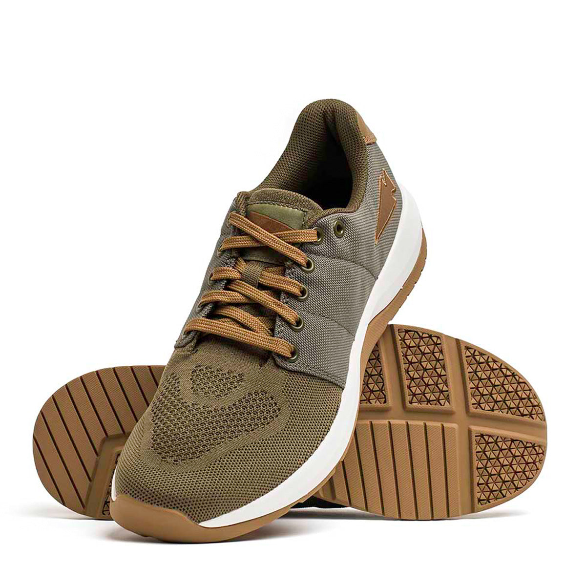 A pair of GORUCK's Men's Ballistic Trainers in Ranger Green with white soles and Coyote Reflective Spearhead laces. These functional fitness shoes feature a stylish mesh design, 3X Support, and a textured rubber outsole for enhanced grip. One shoe is positioned upright while the other is laid flat to display the sole pattern.