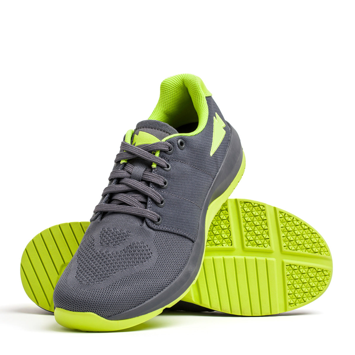 Introducing the Women's Ballistic Trainers in Wolf Grey and Acid Lime, designed by GORUCK. These athletic shoes are crafted from durable CORDURA® Ballistic Nylon, featuring bright acid lime soles and reflective spearhead accents. One shoe stands upright while the other reveals the tread pattern, ideal for functional fitness enthusiasts. Mesh detailing and laces provide enhanced breathability and stylish appeal.