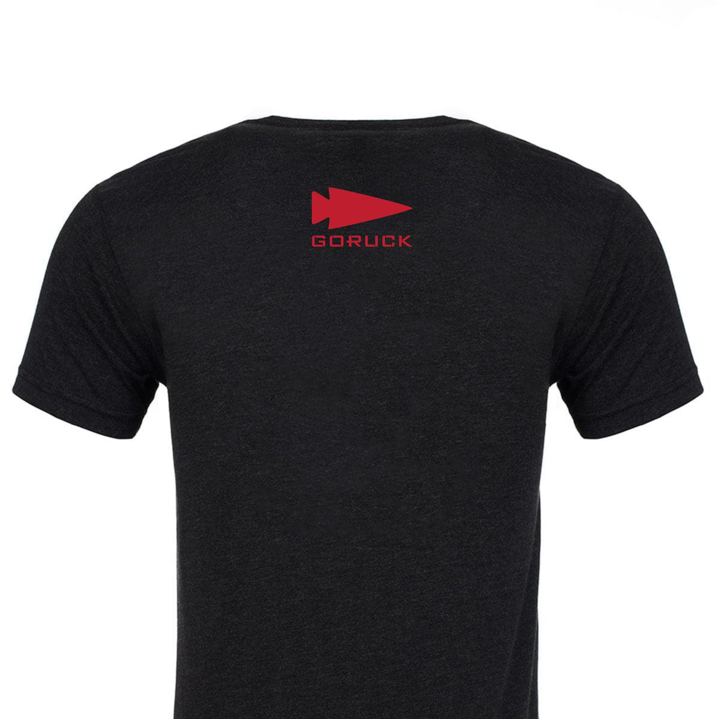 The back of the Bragg GORUCK Challenge Tee - Tri-Blend in black showcases a bold red "GORUCK" and arrow design near the neckline, embodying the spirit and endurance of Special Forces training. Crafted from premium tri-blend fabric, it represents exceptional quality.