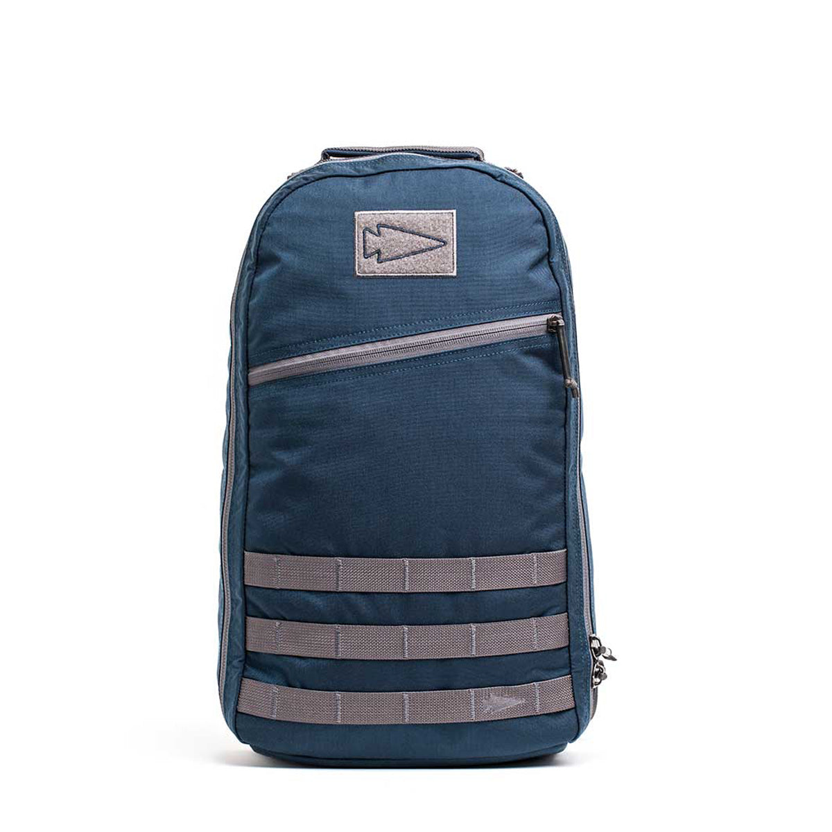 The Bullet Ruck Classic - Cordura, a 15L backpack in blue with grey accents, features a patch design and multiple compartments. Ideal for rucking adventures or everyday use, it is crafted from durable Cordura material.