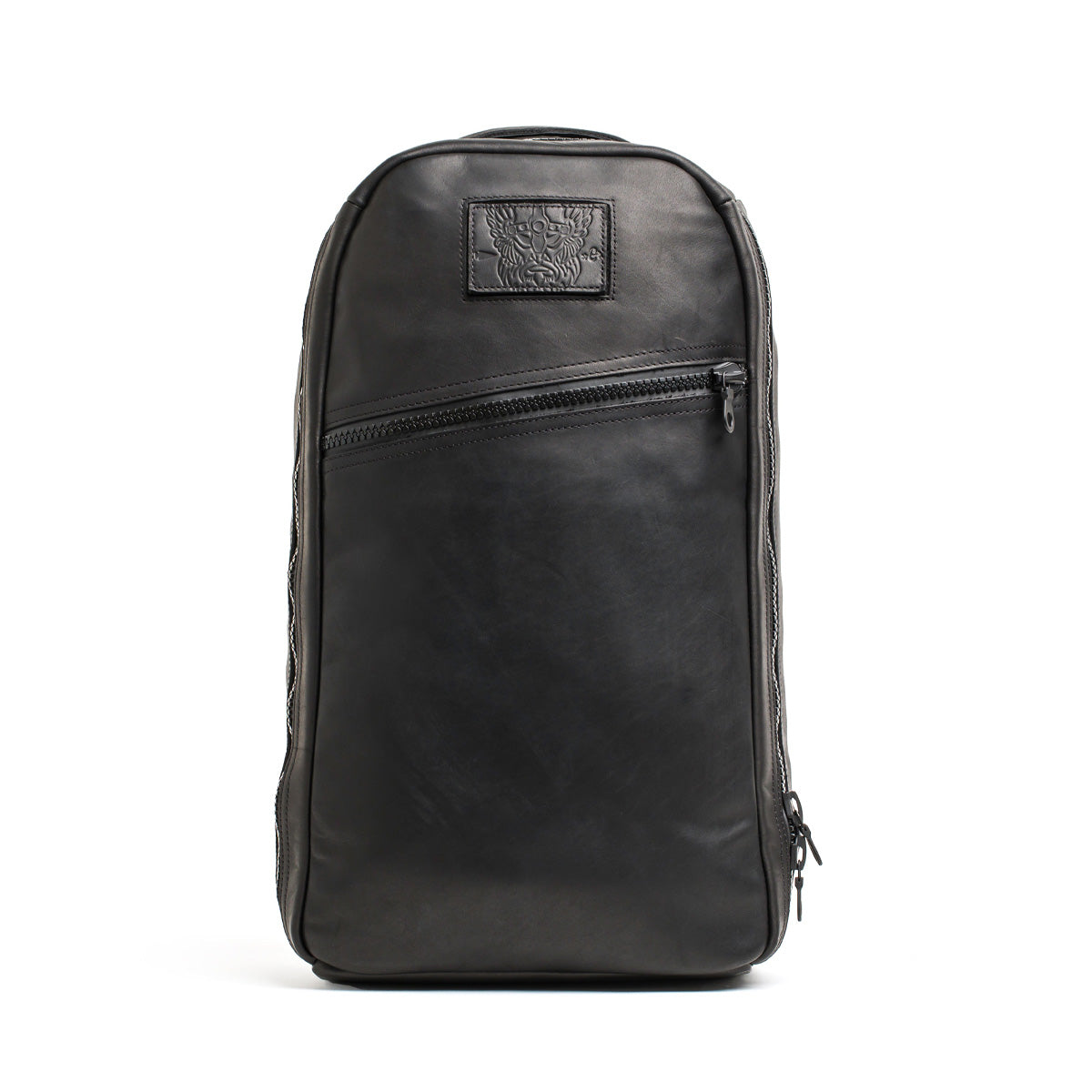 Introducing the Bullet Ruck x Carryology - Berserker Viking by GORUCK: a sleek black leather backpack with a rectangular shape that draws inspiration from the Viking Bullet Ruck. It boasts a front zipper pocket and a subtle embossed design on a small patch near the top, all while maintaining a modern, minimalist look.