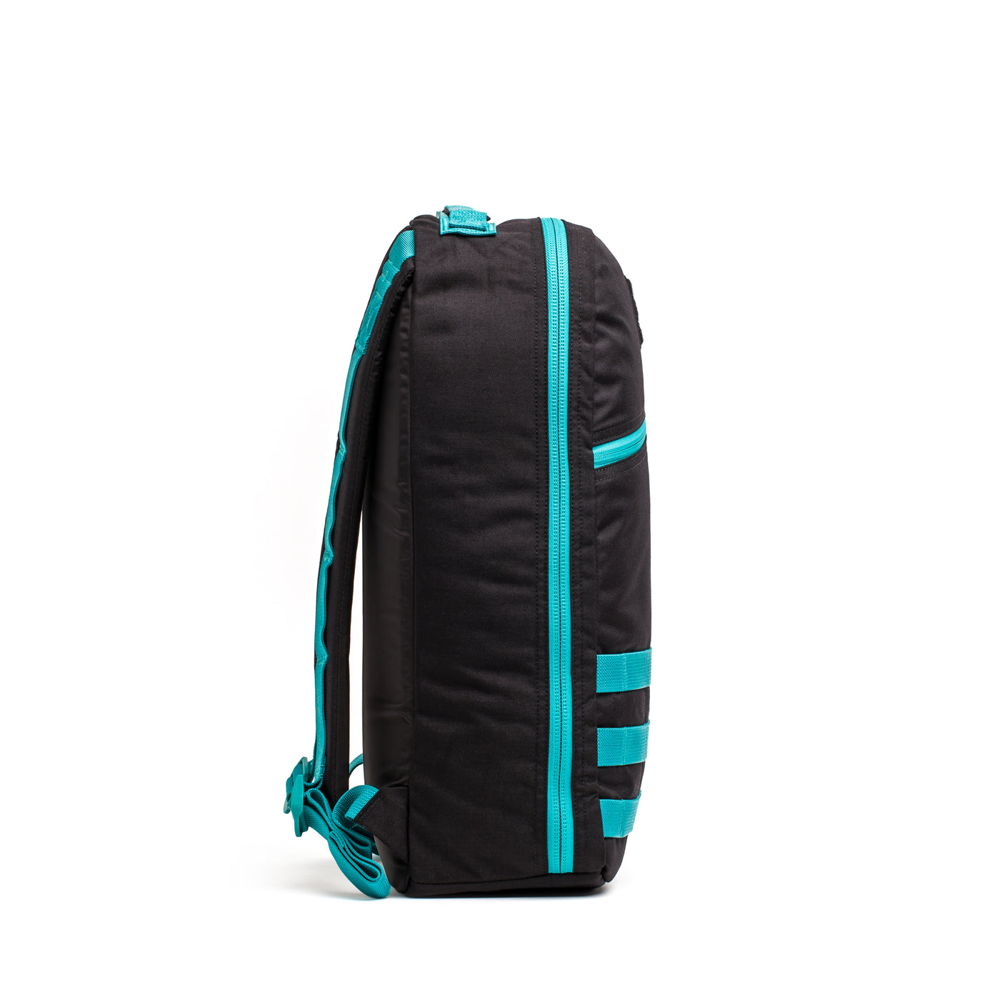 A side view of the Bullet Ruck Classic - Cordura, a black daypack with a streamlined design and turquoise accents and zippers, set against a white background.