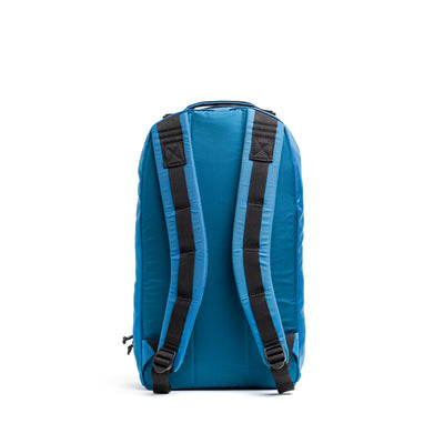 The Bullet Ruck - Ripstop ROBIC® is a blue 15L daypack with extra padded straps and a top handle, made from durable Robic nylon. Displayed on a white background, it combines practicality with style.