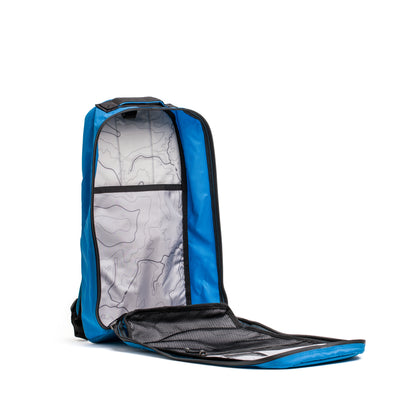 The Bullet Ruck - Ripstop ROBIC® is a 15L daypack with a blue exterior made from durable Robic nylon. It has an unzipped main compartment lined with a topographic map pattern, a convenient mesh pocket, and extra padded straps for added comfort on every adventure.