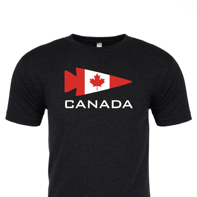 This black tri-blend tee by vendor-unknown showcases a red triangular pennant with a maple leaf inside, evoking the Canadian flag. "CANADA" is prominently displayed beneath, providing a chic salute to national pride. The GORUCK Canada Tee - Tri-Blend seamlessly merges comfort and style in an iconic design.