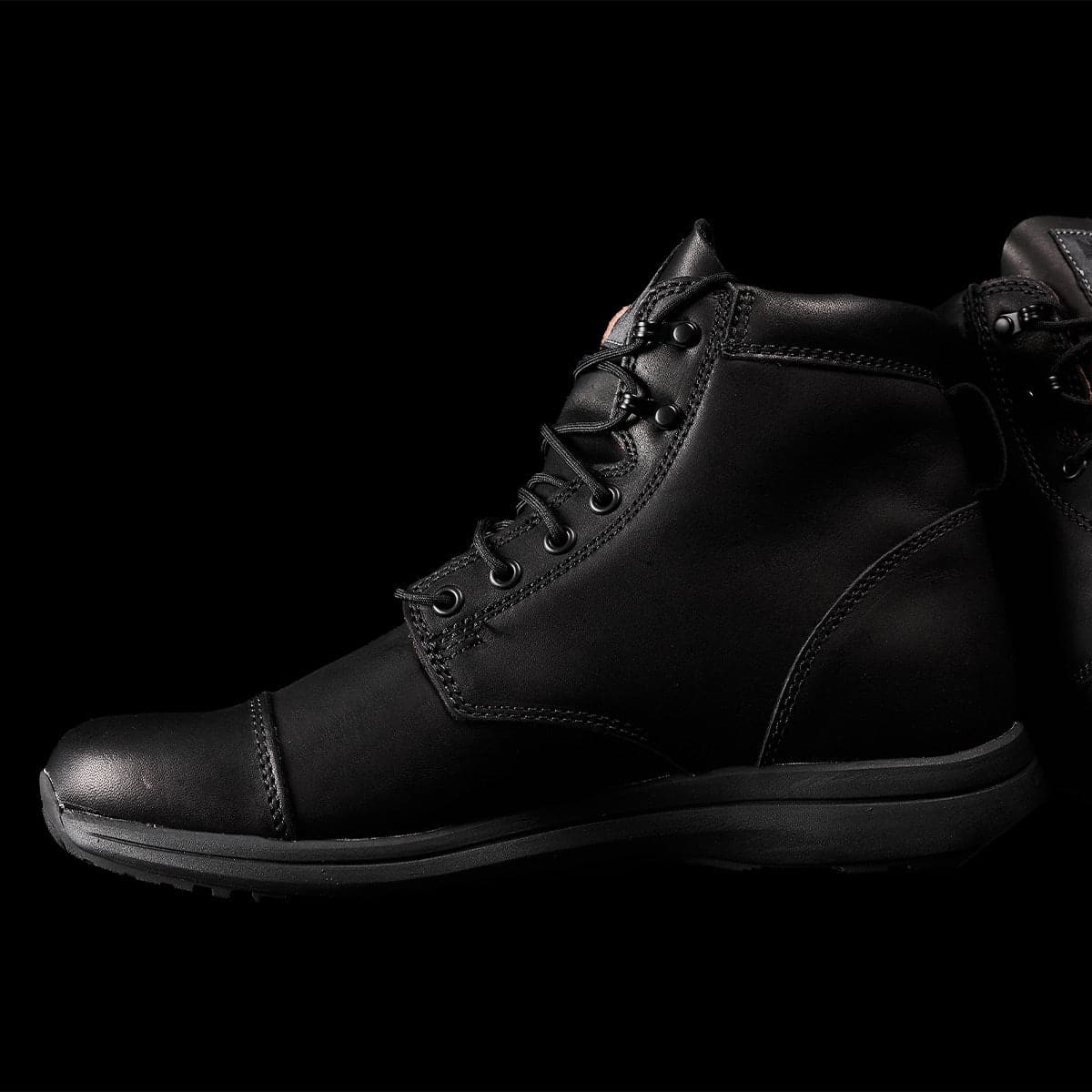 The MACV-1 Traveler x Carryology - Berserker Viking boots by GORUCK are a pair of black leather travel boots with laces, showcasing a sleek and minimal design, set against a solid black background. These limited edition boots feature a high ankle, rugged sole, and water-resistant leather.