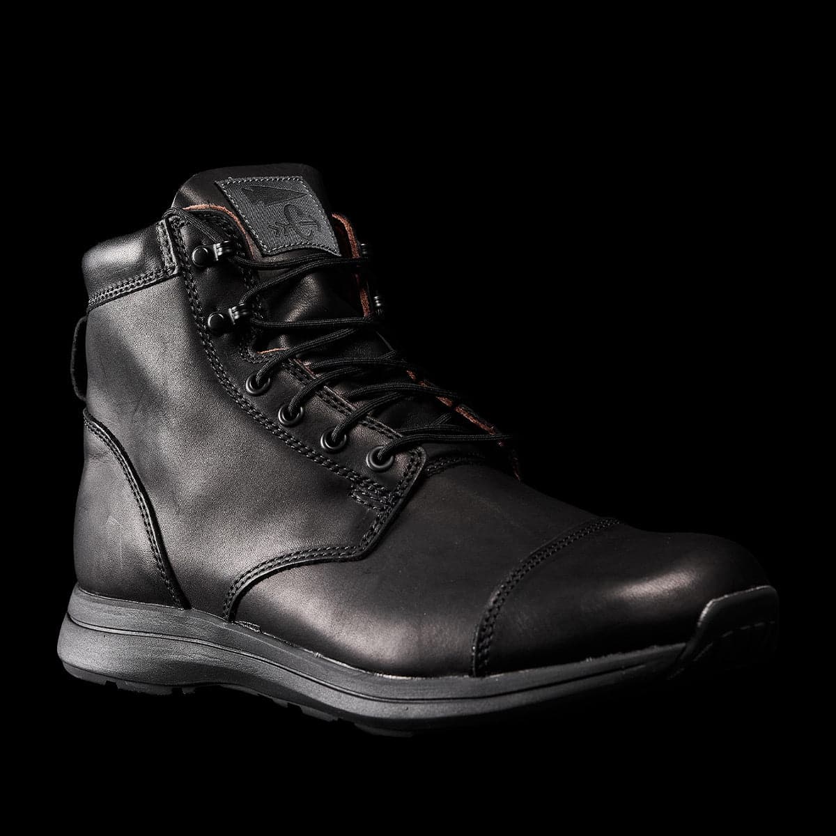 Set against a plain black background, the limited edition MACV-1 Traveler x Carryology - Berserker Viking boot by GORUCK showcases intricate stitching, robust laces, and a cushioned sole. Its high ankle design and water-resistant leather exude durability and style—ideal for travel adventures.