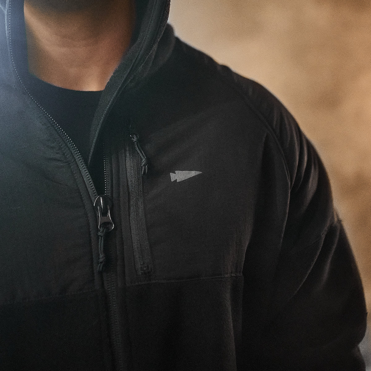 Wearing the Men’s Task Force Dagger Jacket - Polartec Fleece, with its small arrow logo on the chest, exudes an aura of mystery and precision reminiscent of Special Forces gear.