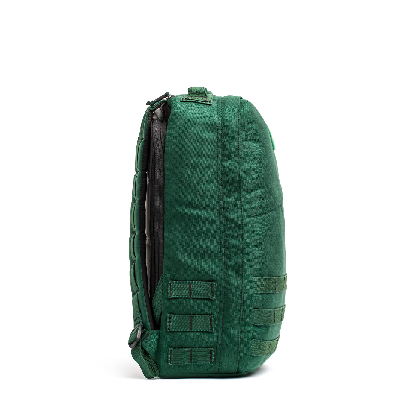 Side view of a green tactical backpack, similar to the GORUCK GR1 USA - Cordura (The Original Ruck), featuring multiple compartments and straps on a white background.