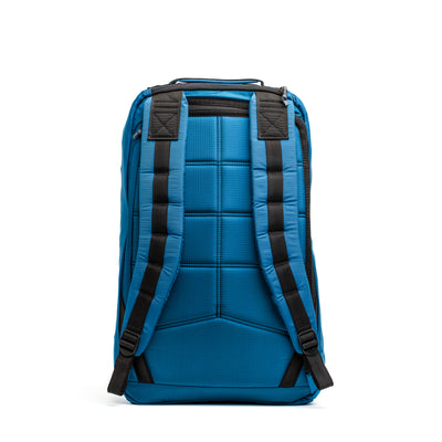 The GR1 USA - Ripstop ROBIC® by GORUCK, featuring a grid pattern in blue with black straps, stands against a white background, providing both style and ultra-lightweight convenience.