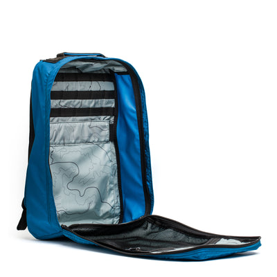 Open the GR1 USA - Ripstop ROBIC® by GORUCK in blue, an ultra-lightweight rucksack with organized compartments and a topographical interior design, set against a white background.