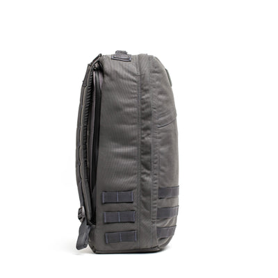 Side view of the GR1 USA - Cordura backpack by GORUCK, a rugged rucksack originally designed with Special Forces in mind, featuring multiple straps and compartments.