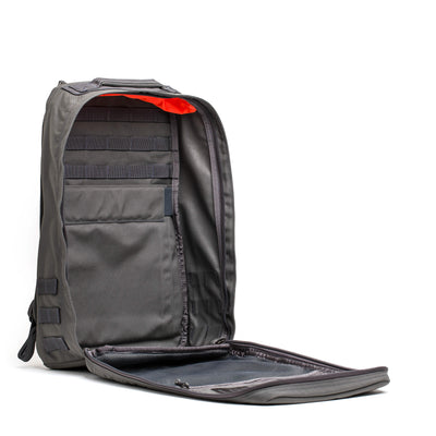 The GR1 USA - Cordura (The Original Ruck) by GORUCK is open, showcasing its orange interior lining and multiple compartments, reminiscent of the reliable gear used by Special Forces.