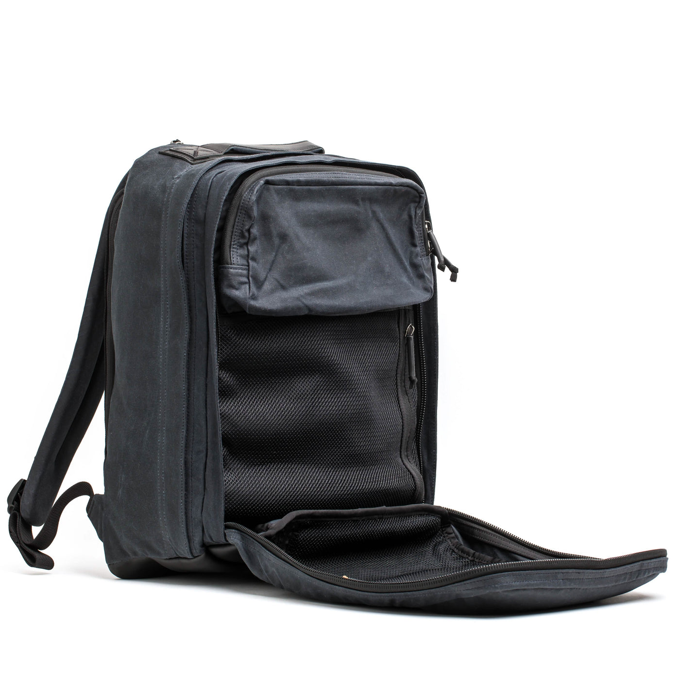 The GR2 - Waxed Canvas by GORUCK, in a sleek black finish, is open to reveal its spacious interior featuring mesh pockets. Crafted from durable waxed duck canvas, it stands upright on a white background, highlighting its multiple compartments and timeless style.