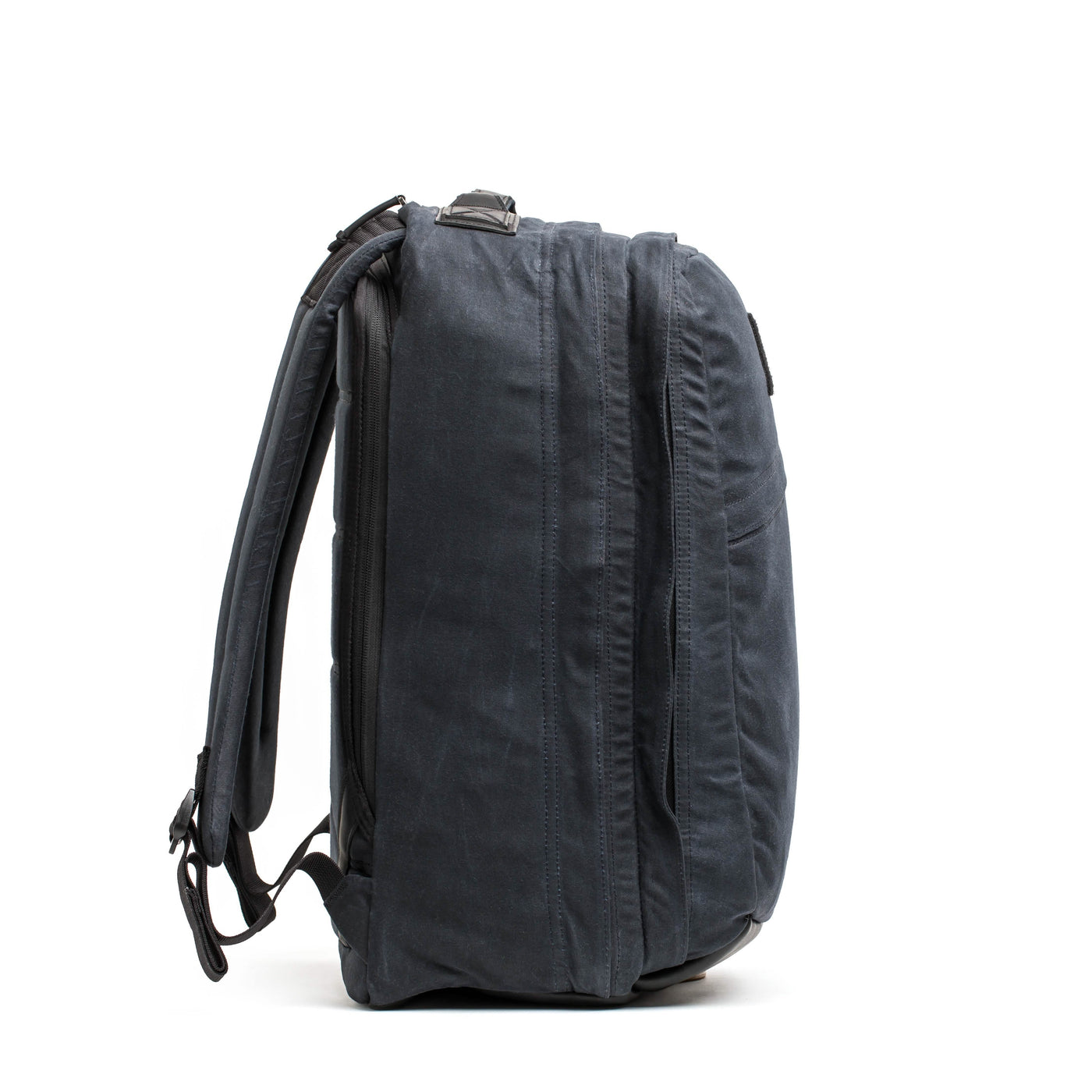 The GR2 - Waxed Canvas backpack from GORUCK stands upright, featuring a dark gray color with multiple zippered compartments and adjustable straps. Its sleek, minimalist design is visible from a side view against a plain white background, reminiscent of a Heritage Retro Rucksack.