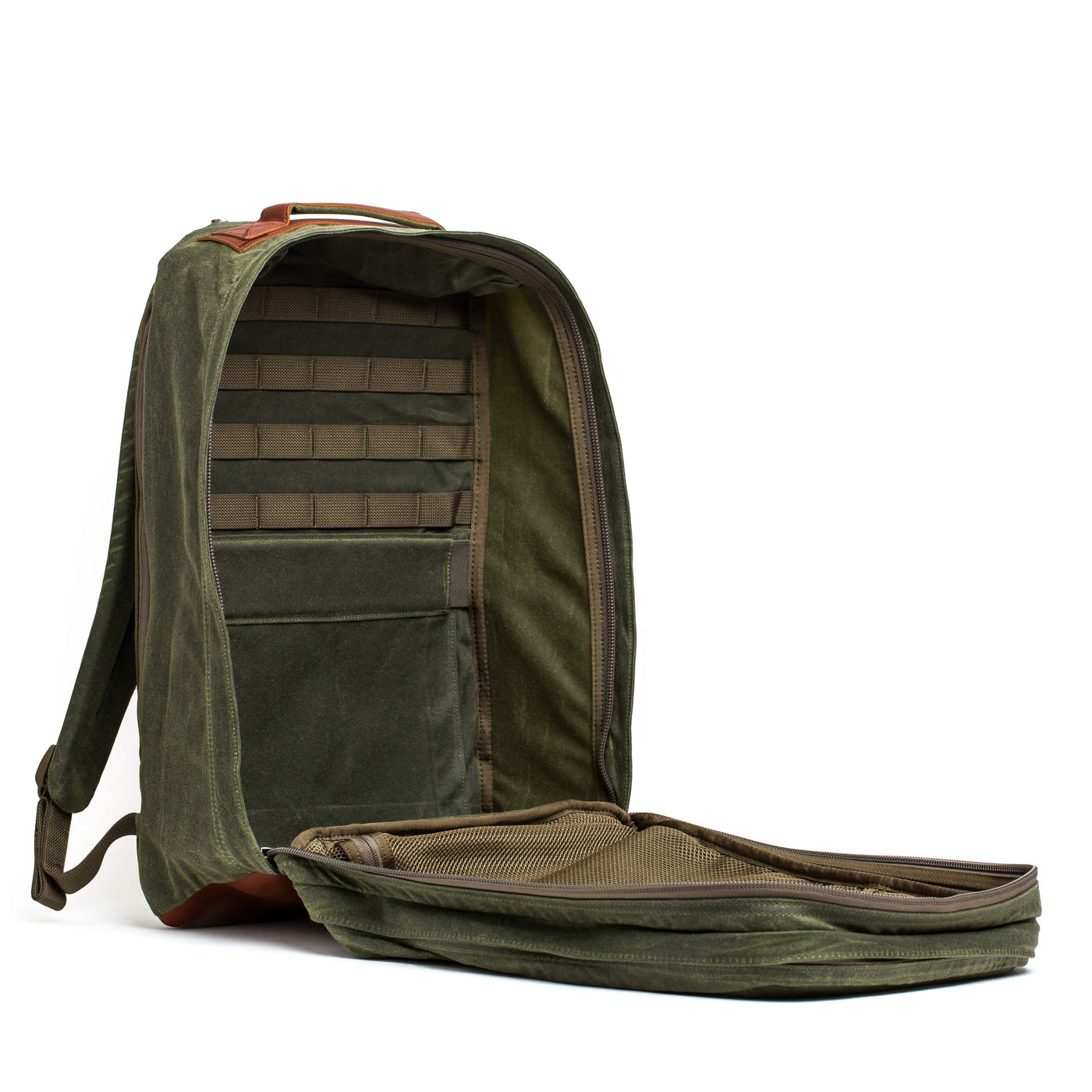 A GR2 - Waxed Canvas rucksack from GORUCK is open, showcasing a spacious interior with various compartments. The rugged exterior is crafted from waxed duck canvas and features a Red Wing leather handle on top. The back is equipped with padded straps for added comfort.