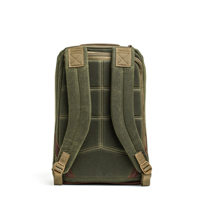 Introducing the GORUCK GR1 USA - Heritage backpack, featuring padded shoulder straps and intricate stitch detailing in green. Its quilted back panel offers comfort during wear, while the rugged waxed duck canvas enhances its retro appeal. Designed with a structured rectangular shape, this backpack is perfect for any adventure.