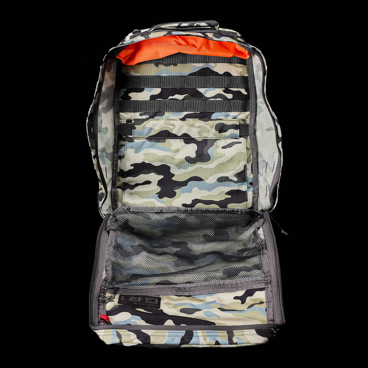 The GR1 USA - Cordura (The Original Ruck) by GORUCK, inspired by Special Forces gear, features an open camouflage design with multiple compartments on a sleek black background.