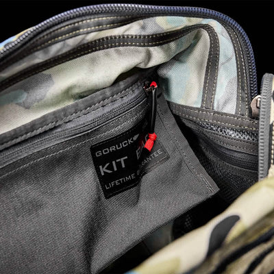 Open camo-patterned Kit Bag with "GORUCK KIT" label and red zipper pull, reminiscent of an Aviator's Kit Bag favored by Special Forces.