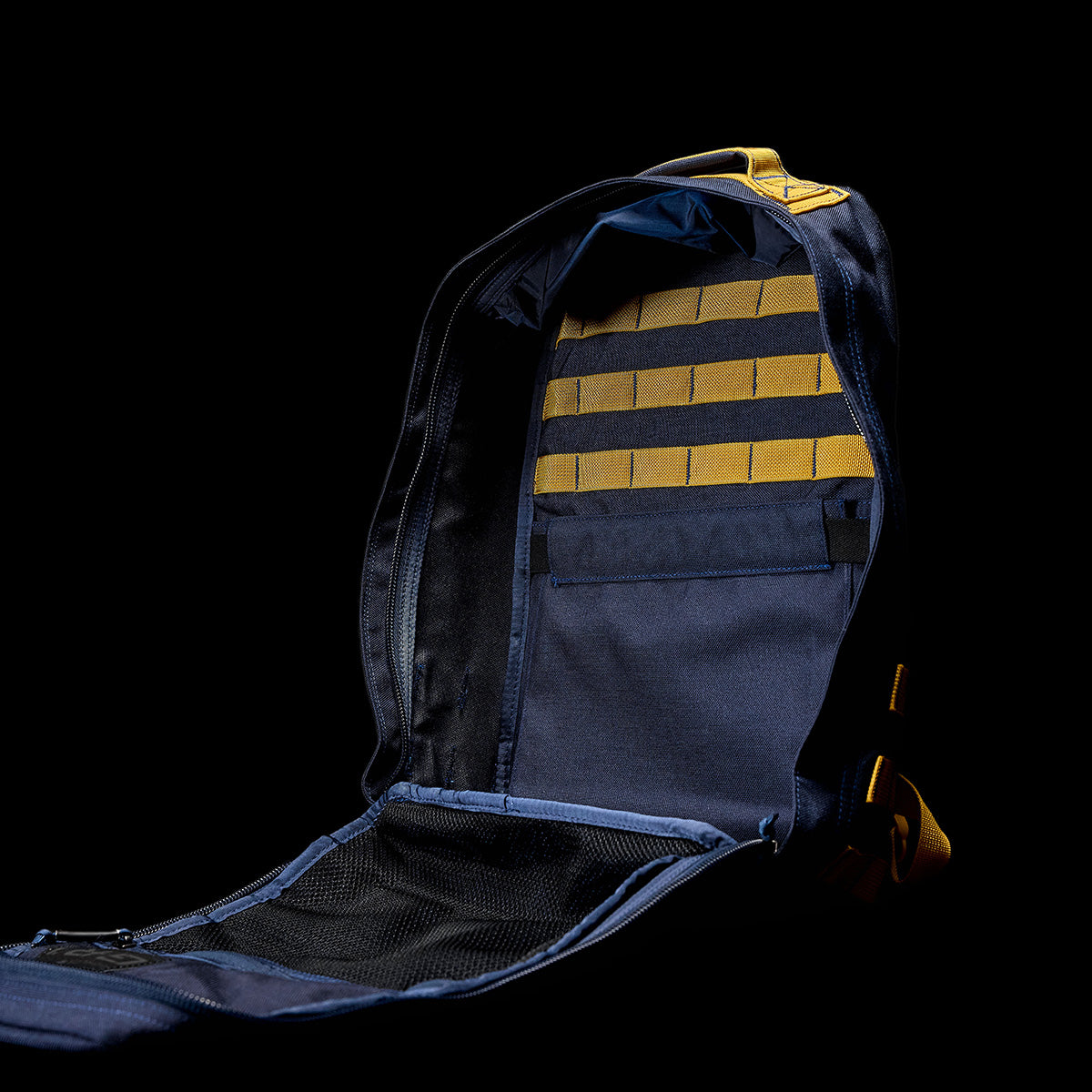 Against a black backdrop, display the GR1 USA - Cordura (The Original Ruck) in blue, featuring multiple compartments and crafted to endure the harshest conditions. Ideal for Special Forces operations or your upcoming GORUCK Challenge.