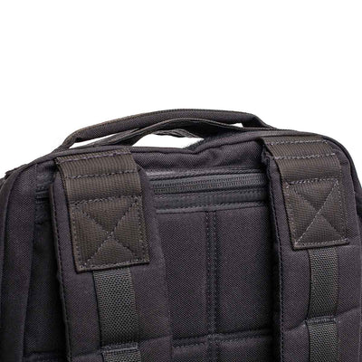 Close-up of the GR1 USA Throwback, a black backpack made from durable 1680 Ballistic Nylon, featuring padded straps, a top handle, and an ultra-protective laptop compartment.