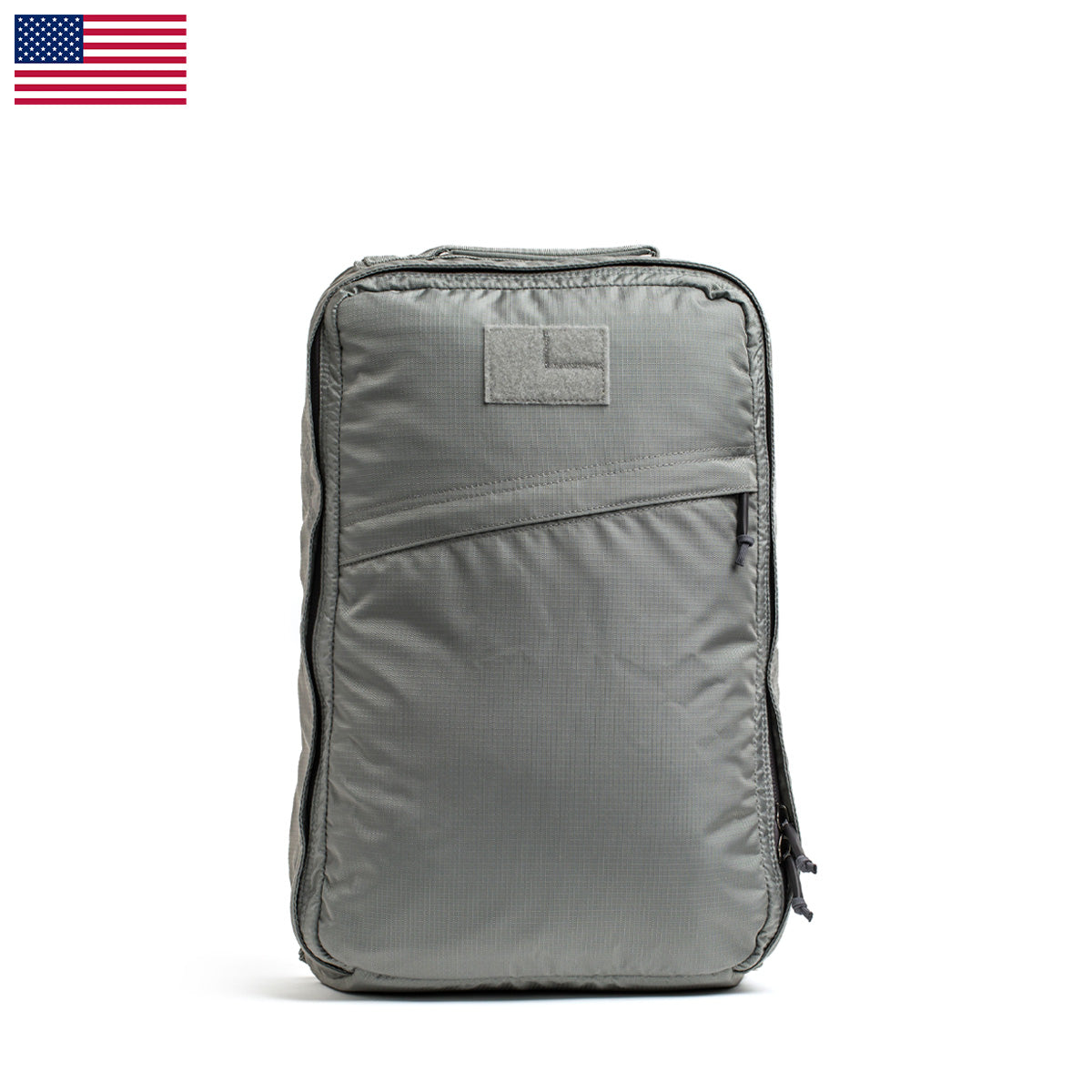 The GR1 USA - Ripstop ROBIC® by GORUCK is a gray rectangular backpack made from ripstop nylon, featuring a small USA flag in the top left corner. Ultra lightweight and water resistant, it’s perfect for any adventure.