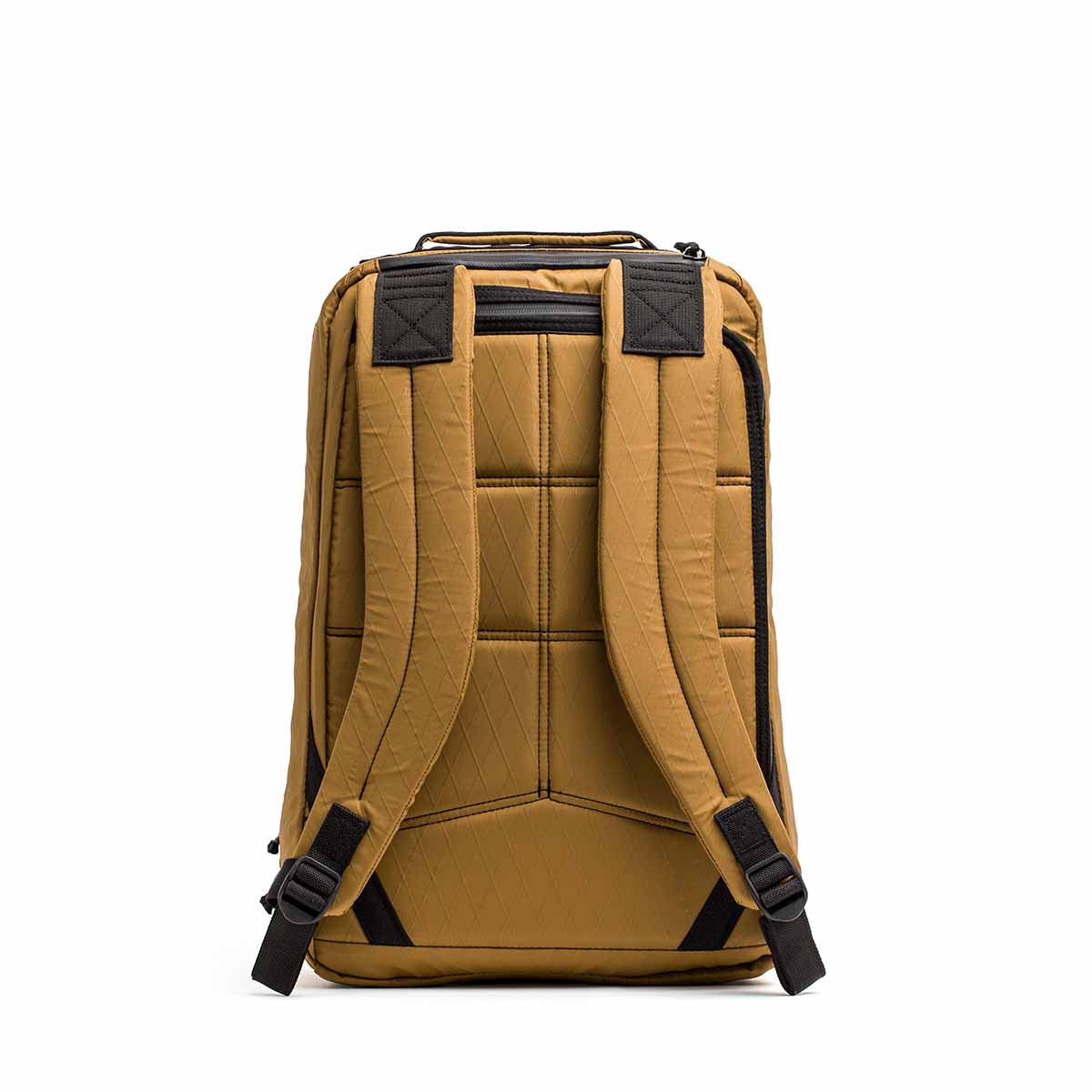 Back view of the GR1 USA - X-PAC tan backpack featuring black straps, padded sections, and AquaGuard zippers on a plain white background.