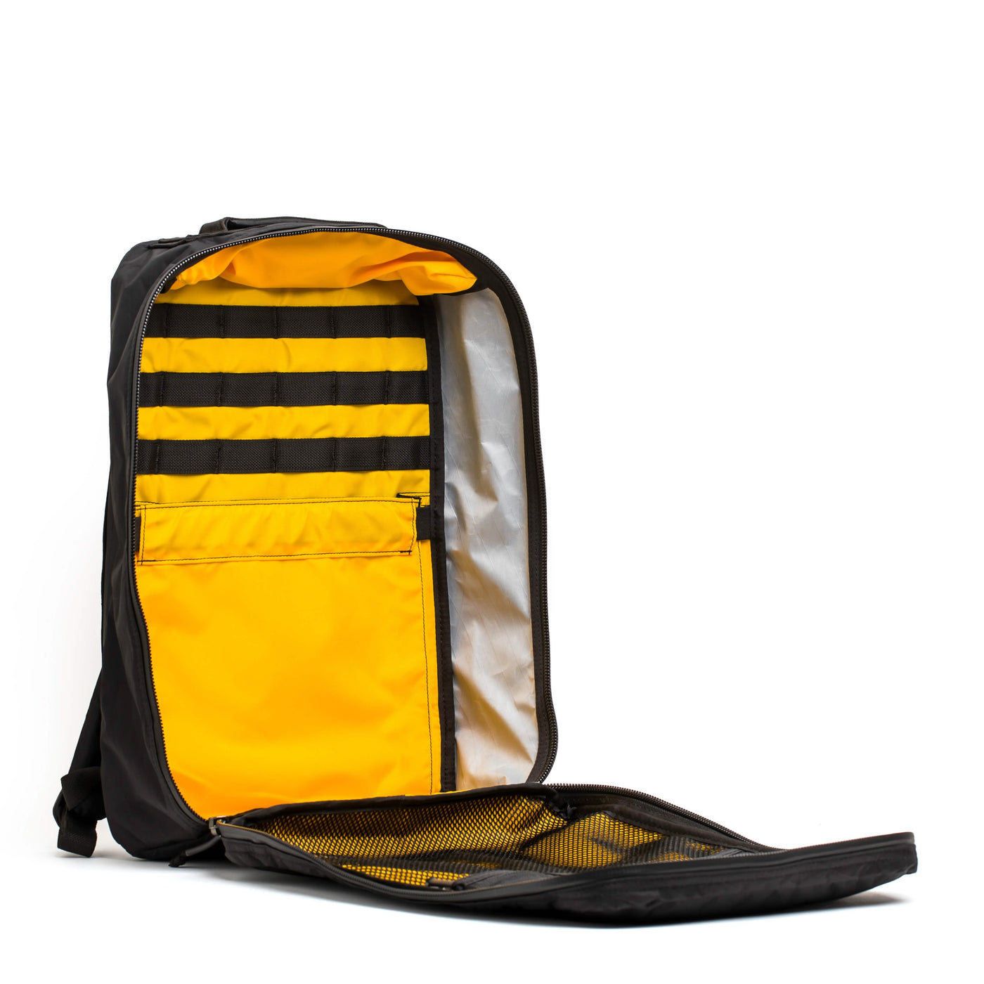 The GR1 USA - X-PAC rucksack by GORUCK, in black and yellow, is displayed open on a white background, highlighting its waterproof design with interior compartments and mesh pockets.