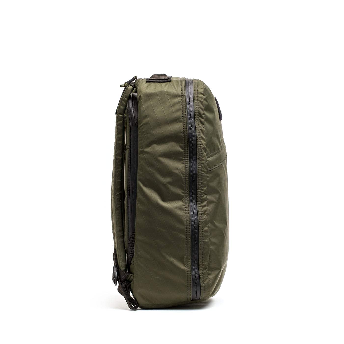 Side view of a green GR1 USA - X-PAC by GORUCK, showcasing a black zipper and ultra-durable, adjustable straps.